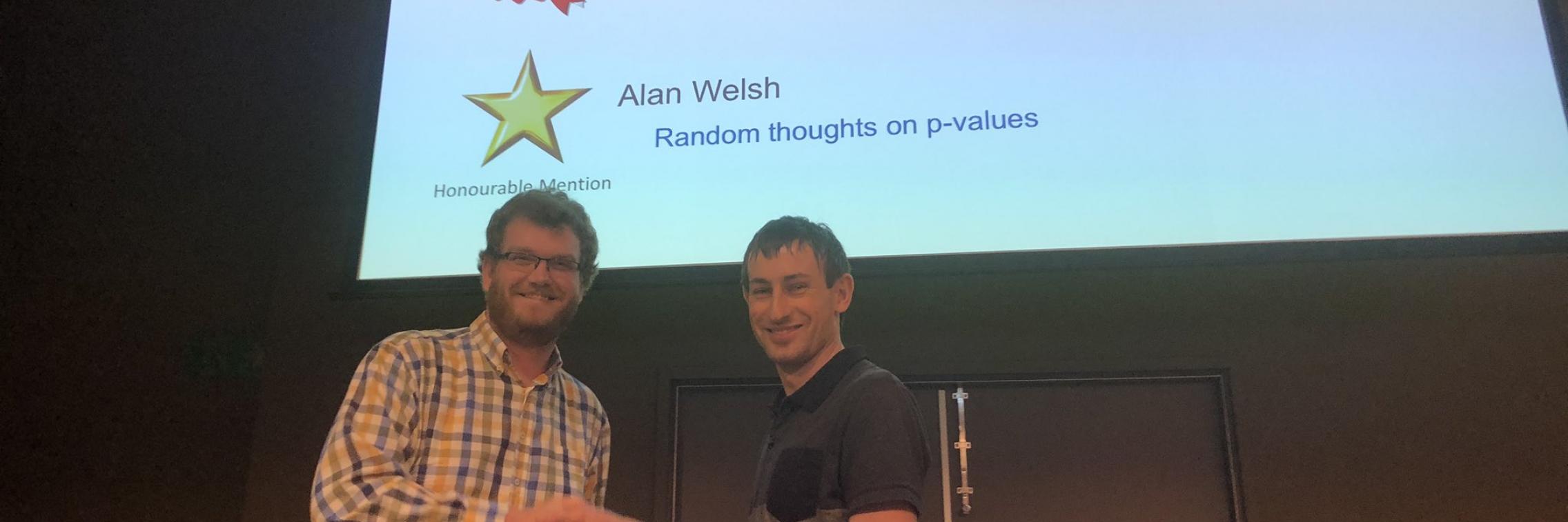 Sam Rogers receives his prize for Best Poster at the conference