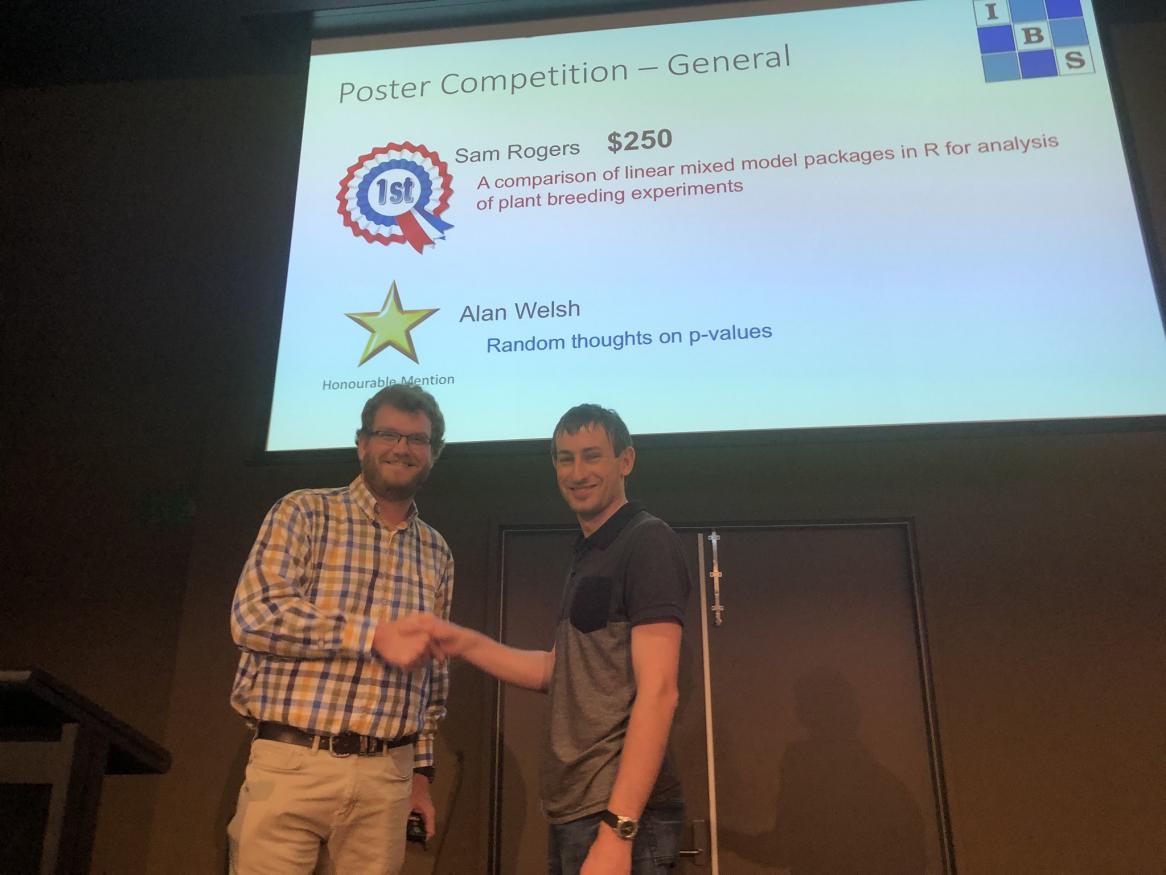 Sam Rogers receives his prize for Best Poster at the conference