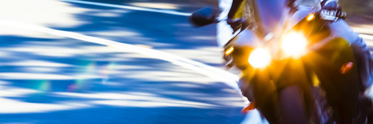 Image of motorcyclist in curve of road