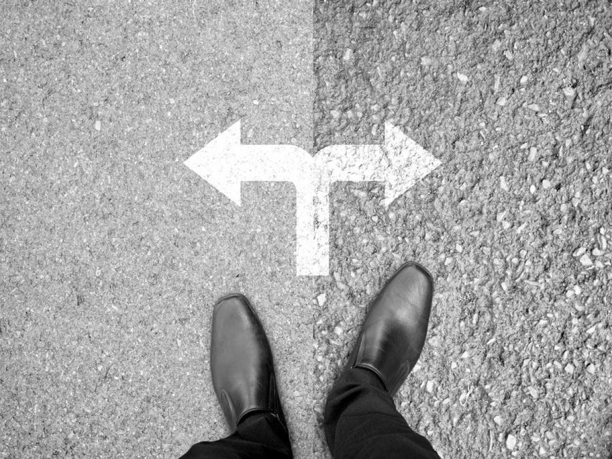 Looking down at feet with arrows in front pointing in different directions