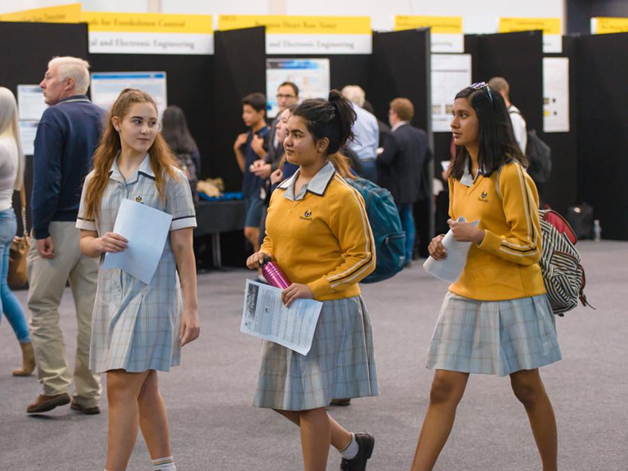 Young female students walking and talking