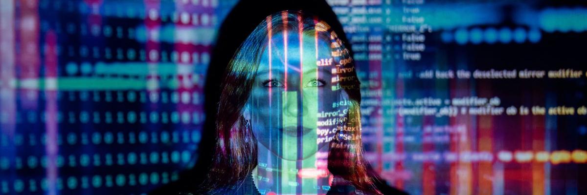 HTML code reflected over a woman's face 