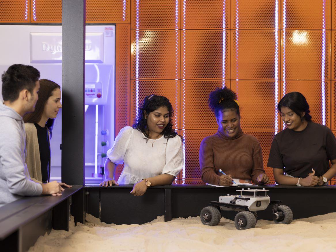 Students with a rover in the EXTERRES lab