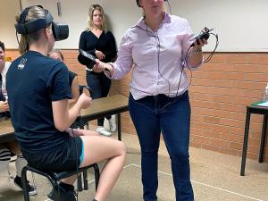 Animal science student Tamika Henry talks with ABC Rural host Cassie Hough while undertaking cattle handling training via virtual reality