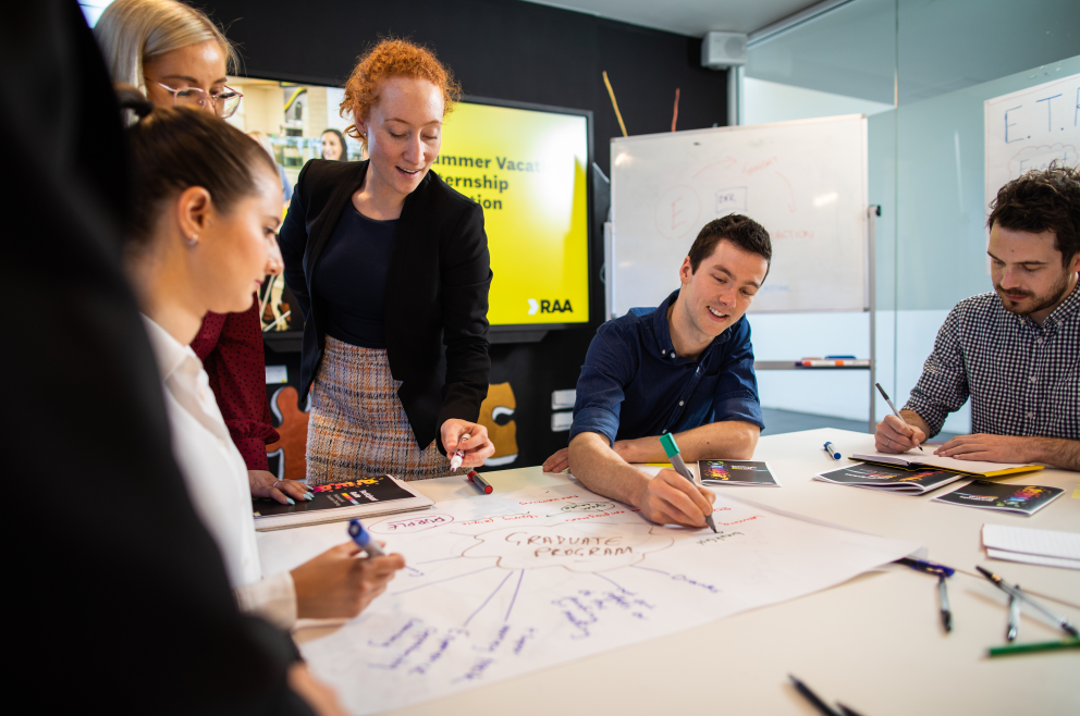 Students gathered around a table at the RAA