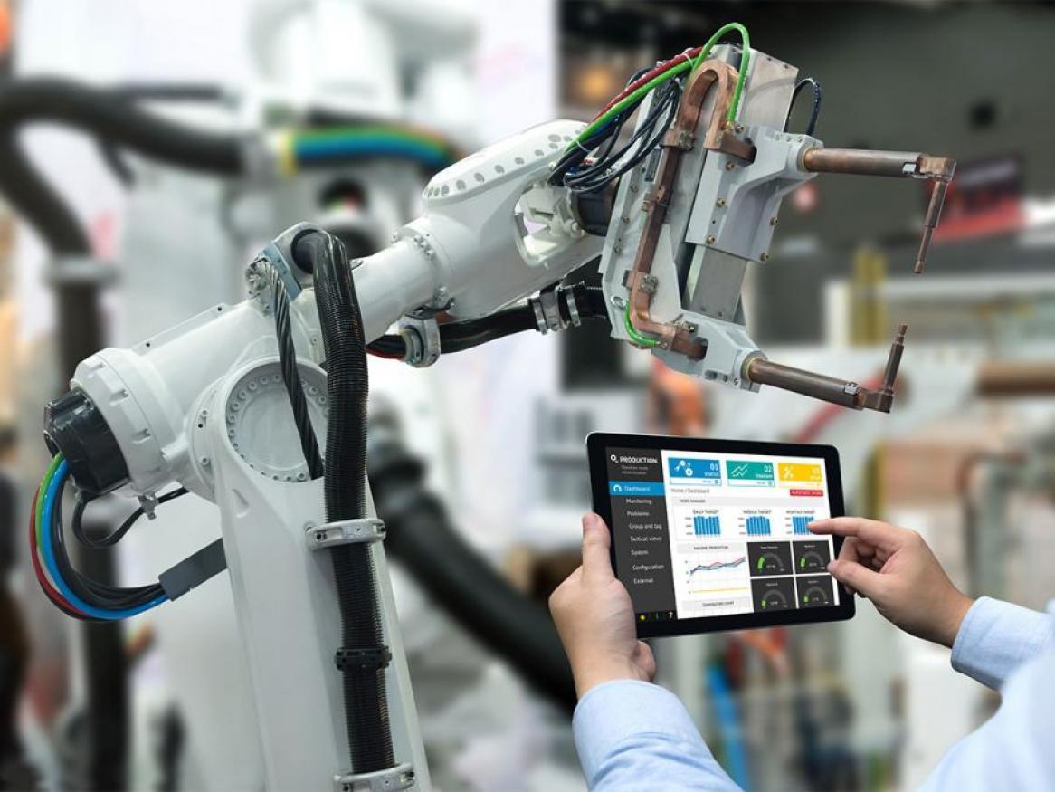 Robotic arm and a person holding a table which is controlling the arm