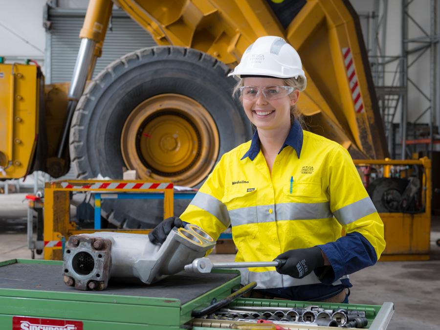 Glencore female apprentice working with tools