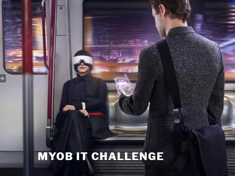 Picture shows a woman and a man on a train, he is holding a futuristic phone and she is wearing a visual head set.