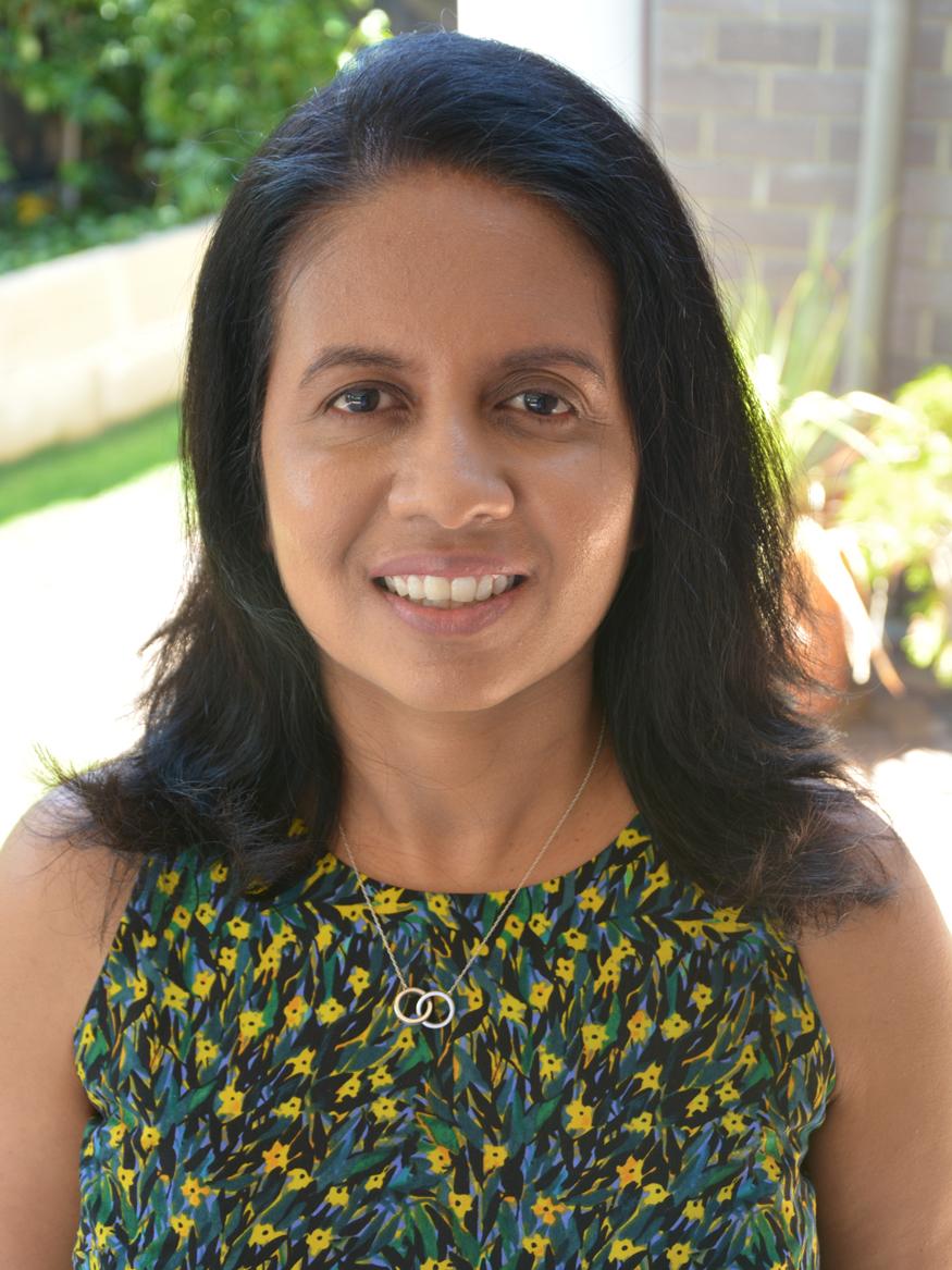 Thushari Atapattu from the School of Computer Science wears a green flower top and is smiling.