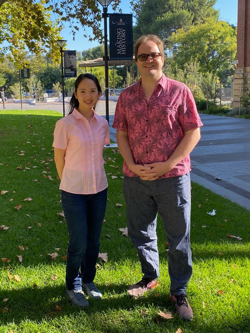 Chuengsatiansup and Wagner standing on the University of Adelaide's lawn with "making history" in the background