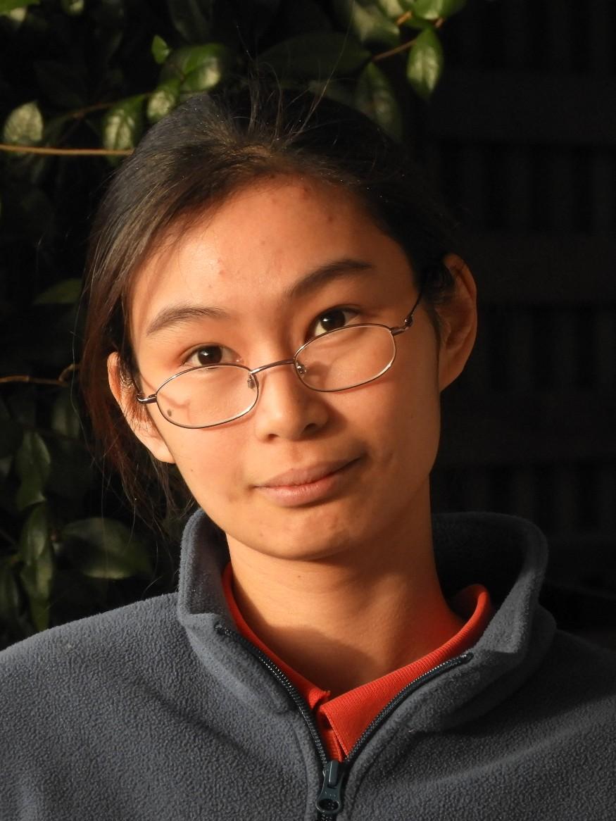 Lady (Vivien Heng) in glasses looking direct at camera