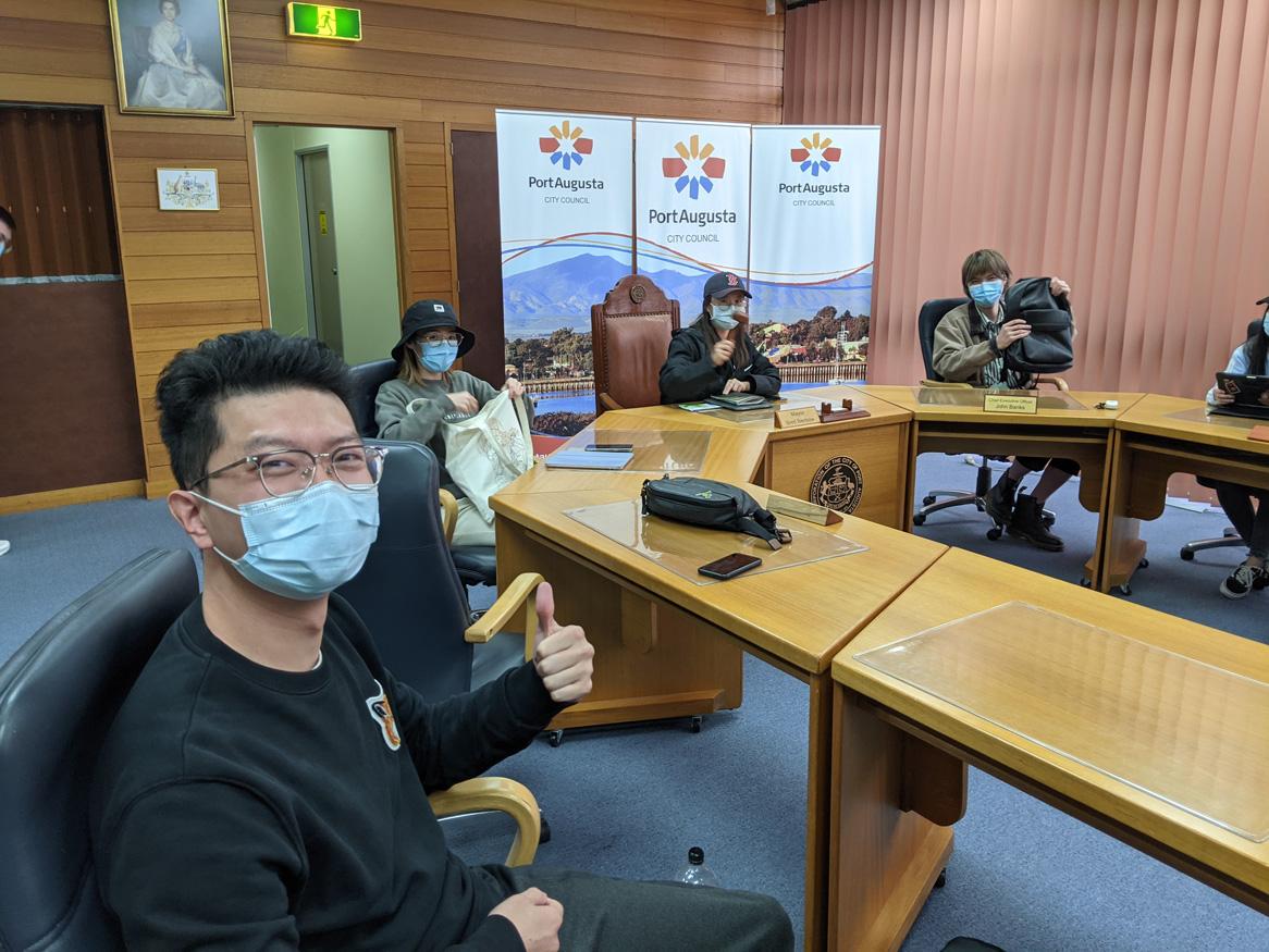 group of people in meeting room wearing facemasks