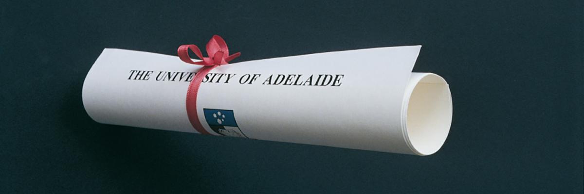 Graduation scroll tied with a red ribbon