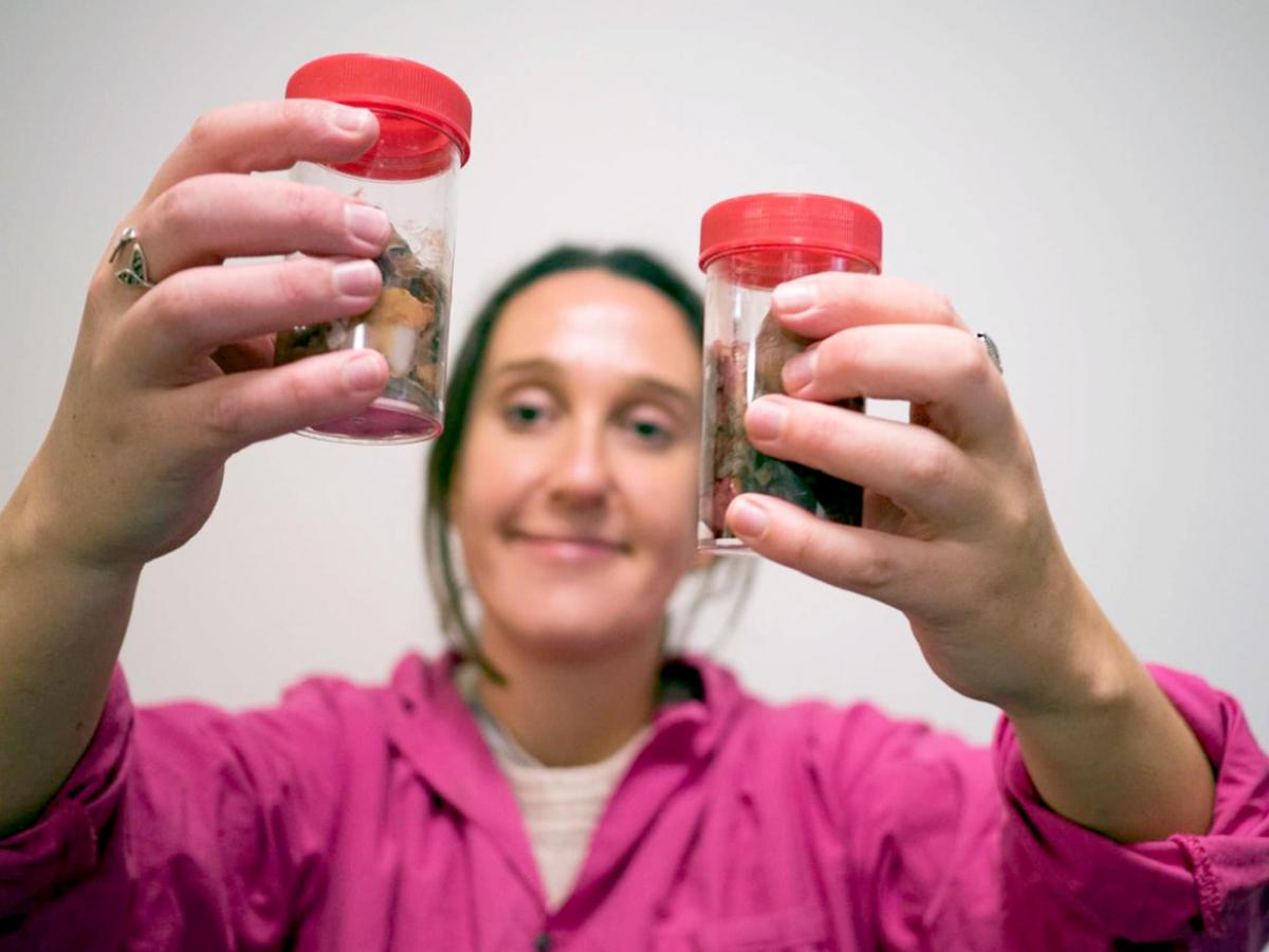 Lead researcher of the study, Nina Wootton, with some jars of microplastics found in fish