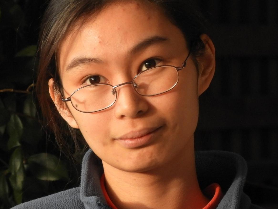 Lady (Vivien Heng) in glasses looking direct at camera